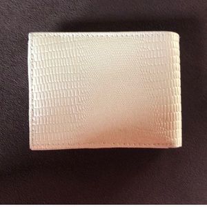 Cream colored leather wallet.